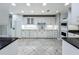 Modern white kitchen with sleek countertops, appliances, and ample cabinet space at 504 Banning Beach Rd, Tavares, FL 32778