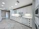Spacious white kitchen with tile floors, recessed lighting, and ample cabinet space at 504 Banning Beach Rd, Tavares, FL 32778