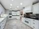 Well-lit kitchen showcasing white cabinetry, modern appliances, and granite countertops at 504 Banning Beach Rd, Tavares, FL 32778