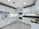 Bright kitchen featuring white cabinets, modern appliances, and stylish tile backsplash and flooring at 504 Banning Beach Rd, Tavares, FL 32778