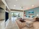 Spacious living area with neutral decor, large windows, and access to the patio at 504 Banning Beach Rd, Tavares, FL 32778