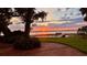 Scenic waterfront view featuring a tranquil lake and stunning sunset at 504 Banning Beach Rd, Tavares, FL 32778