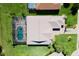 Aerial view of a beautiful home with a large pool and screen enclosure at 5418 Sandy Hill Ln, Lady Lake, FL 32159