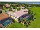 Aerial view of a home with a screened-in pool, beautiful backyard, and surrounding neighborhood and lake at 5418 Sandy Hill Ln, Lady Lake, FL 32159