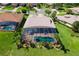 Aerial view of a home with a screened pool, surrounded by manicured lawn and lush landscaping at 5418 Sandy Hill Ln, Lady Lake, FL 32159