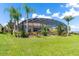 Well-manicured lawn with an enclosed lanai perfect for outdoor relaxation and entertainment at 5418 Sandy Hill Ln, Lady Lake, FL 32159