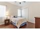 Comfortable bedroom with hardwood floors, large windows, and a cozy bed at 5418 Sandy Hill Ln, Lady Lake, FL 32159