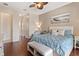 Bedroom with wood floors, ceiling fan, and a sitting area at 5418 Sandy Hill Ln, Lady Lake, FL 32159