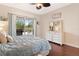 Bedroom with a view to the outdoor kitchen, swimming pool, and green landscape at 5418 Sandy Hill Ln, Lady Lake, FL 32159