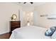 Bedroom boasts hardwood floors, a ceiling fan and view to hallway at 5418 Sandy Hill Ln, Lady Lake, FL 32159