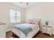 Bedroom with wood floors, white walls, a ceiling fan and a bed with a blue blanket at 5418 Sandy Hill Ln, Lady Lake, FL 32159