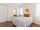 Bedroom featuring hardwood floors, closet and window view at 5418 Sandy Hill Ln, Lady Lake, FL 32159