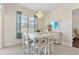 Dining room with chandelier, large window, and view of the backyard at 5418 Sandy Hill Ln, Lady Lake, FL 32159