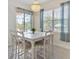 Dining room with backyard views through large window and sliding glass doors at 5418 Sandy Hill Ln, Lady Lake, FL 32159