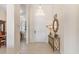 Bright and airy foyer featuring tiled floors, neutral walls, and a decorative console table at 5418 Sandy Hill Ln, Lady Lake, FL 32159