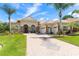 Charming home with a beautiful brick driveway, lush landscaping, and a welcoming three-car garage at 5418 Sandy Hill Ln, Lady Lake, FL 32159