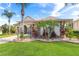 Attractive landscaping, palm trees, and stone accents enhance the curb appeal of this inviting home at 5418 Sandy Hill Ln, Lady Lake, FL 32159