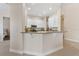 Well-lit kitchen with a granite-topped breakfast bar and sleek white cabinetry at 5418 Sandy Hill Ln, Lady Lake, FL 32159
