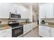 Modern kitchen with stainless steel appliances and granite countertops, perfect for cooking at 5418 Sandy Hill Ln, Lady Lake, FL 32159
