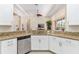 Stylish kitchen with stainless steel appliances, granite countertops, and white cabinetry at 5418 Sandy Hill Ln, Lady Lake, FL 32159