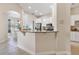 Bright kitchen featuring granite countertops, white cabinets, and an open layout at 5418 Sandy Hill Ln, Lady Lake, FL 32159