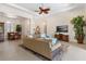 Bright living room featuring tray ceilings, tile floors, comfortable seating, and elegant decor at 5418 Sandy Hill Ln, Lady Lake, FL 32159