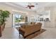 Open-concept living room with large sliding doors to the lanai and access to the kitchen at 5418 Sandy Hill Ln, Lady Lake, FL 32159