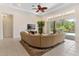 Spacious living room featuring a large sectional sofa and direct access to the outdoor pool area at 5418 Sandy Hill Ln, Lady Lake, FL 32159