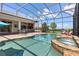 Stunning screened-in pool with attached hot tub, outdoor bar and beautiful backyard views at 5418 Sandy Hill Ln, Lady Lake, FL 32159