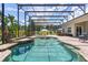 Beautiful backyard oasis features a screened-in pool, spa, fire pit, and outdoor dining area at 5418 Sandy Hill Ln, Lady Lake, FL 32159
