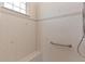 Tiled shower with a built-in bench and safety bar at 5418 Sandy Hill Ln, Lady Lake, FL 32159