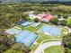 Community amenities featuring multiple tennis courts, a shuffleboard court, a pool, and community buildings at 5507 Laver St, Leesburg, FL 34748