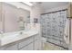 Charming bathroom with a vanity, toilet, and shower with themed anchor curtain at 5507 Laver St, Leesburg, FL 34748