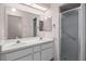 Clean bathroom featuring a double vanity, large mirror and glass-doored shower at 5507 Laver St, Leesburg, FL 34748