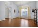 Dining room with wood floors, a large window with curtains, and a hanging chandelier and doorways at 5507 Laver St, Leesburg, FL 34748
