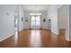 Dining room with wood floors, a large window with curtains, and a hanging chandelier at 5507 Laver St, Leesburg, FL 34748
