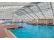 Bright indoor swimming pool with vaulted ceilings at 5507 Laver St, Leesburg, FL 34748