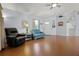 Bright living room with wood floors, a front door, comfortable leather furniture, and a ceiling fan at 5507 Laver St, Leesburg, FL 34748