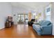 Bright living room with wood floors, a sliding glass doors, and comfortable leather furniture at 5507 Laver St, Leesburg, FL 34748