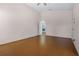 Spacious main bedroom featuring wood floors, vaulted ceilings, and open doorway at 5507 Laver St, Leesburg, FL 34748