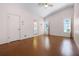 Spacious main bedroom featuring wood floors, vaulted ceilings, and a view of the en suite bathroom at 5507 Laver St, Leesburg, FL 34748