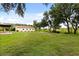 Large backyard with a multi-purpose outbuilding situated on a spacious grassy lot, providing endless possibilities at 5729 Bible Camp Rd, Groveland, FL 34736
