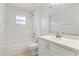 Clean bathroom with tub, shower, and a vanity, offering a serene space for relaxation at 5729 Bible Camp Rd, Groveland, FL 34736