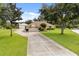 Sprawling property with a long driveway leading to a charming one-story home and outbuilding at 5729 Bible Camp Rd, Groveland, FL 34736