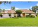 Inviting single-story home with well-manicured lawn and mature landscaping, creating curb appeal at 5729 Bible Camp Rd, Groveland, FL 34736