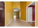 Hallway with tile flooring, leading to hardwood floors and a bright view of the outdoor space at 5729 Bible Camp Rd, Groveland, FL 34736