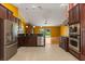Open kitchen features stainless appliances, granite counters, and seamless flow to living area at 5729 Bible Camp Rd, Groveland, FL 34736