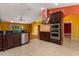 Bright open kitchen with stainless appliances, tile flooring, and seamless flow to the living area at 5729 Bible Camp Rd, Groveland, FL 34736