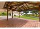 Covered brick patio with a view of the yard, perfect for outdoor entertaining and relaxation at 5729 Bible Camp Rd, Groveland, FL 34736