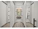 Hallway view of a bathroom with a freestanding tub and decorative tile flooring at 6031 Dora Dr, Mount Dora, FL 32757